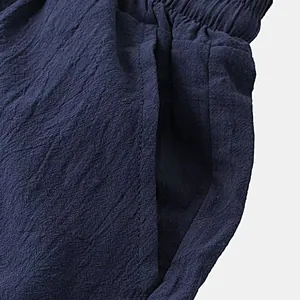 Close-up of navy blue cotton linen shorts featuring elastic waistband and side pocket
