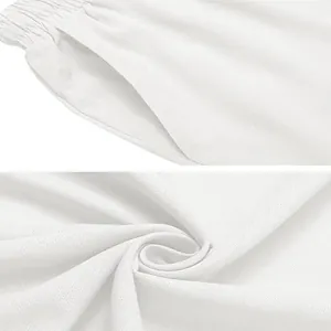 Close-up of white cotton linen fabric and pocket detail of men's beach trousers