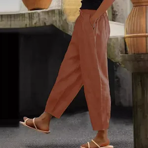 Side view of women's terracotta cotton linen pants with elastic waist and side pockets.