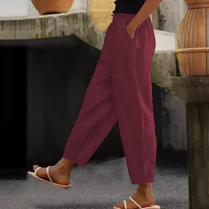 Side view of women's burgundy cotton linen casual pants with elastic waist and pockets