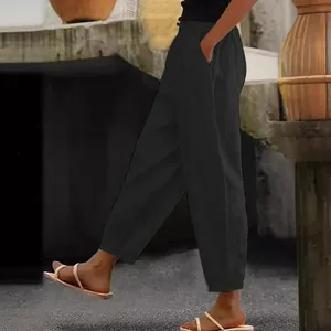 Detail view of women's black linen pants with elastic waist and side pockets