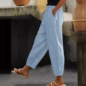 Detail of light blue cotton linen pants featuring side pocket and elastic waist.