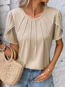 Detail shot of women's khaki pleated round neck T-shirt featuring elegant white lace trim