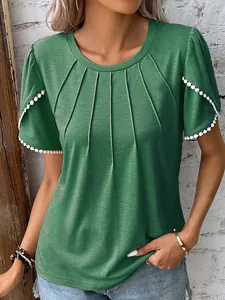 Detail view of green pleated round neck t-shirt with lace trim on sleeves