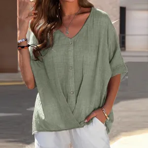 Close-up of sage green cotton linen V-neck blouse with buttons for a casual summer look.
