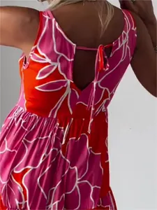 Close-up of back tie-up detail on a vibrant pink and orange floral sleeveless dress