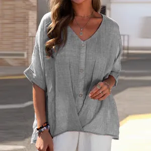 Close-up detail of women's loose grey cotton linen V-neck short sleeve casual shirt