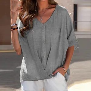 Close-up of a grey loose-fit cotton linen V-neck short sleeve shirt with decorative buttons