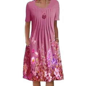 Close-up of pink floral midi dress with pleated round neck and side pockets detail.