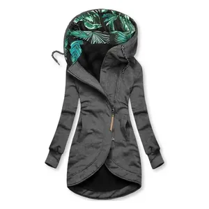 Close-up of asymmetrical zipper and tropical leaf print lining on a grey hoodie.