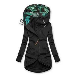 Close-up detail of women's black long sleeve zip hoodie with tropical leaf print lining