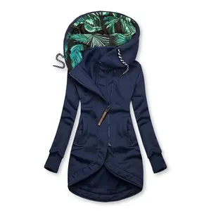 Close-up detail of navy blue women's zip-up hoodie with tropical leaf print hood lining