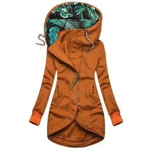 Close-up of caramel orange hoodie with tropical leaf print lining and zipper detail