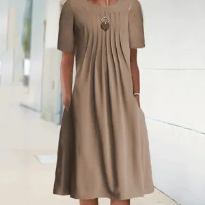 Detail shot of a women's khaki short-sleeved pleated midi dress with side pockets