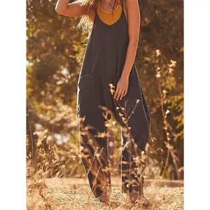 Casual loose charcoal overalls with side pockets for women in outdoor sunlit setting