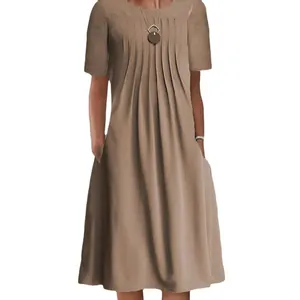 Detailed view of a khaki midi dress featuring elegant pleated chest details and side pockets.