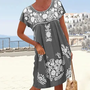Detail of ethnic style grey short sleeve dress featuring white floral embroidery