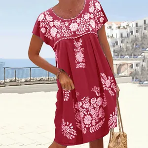 Detailed view of a bohemian burgundy summer dress with intricate floral embroidery