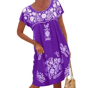 Close-up detail of white floral embroidery on a purple ethnic style summer dress