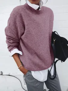 Close-up detail of women's mauve knitted pullover sweater layered over a white shirt