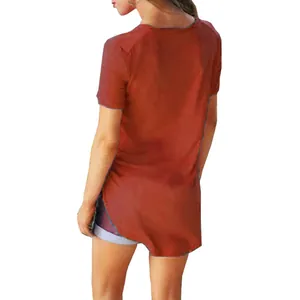 Back view of rust orange short sleeve tunic top with asymmetrical high-low hem