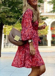 Bohemian red paisley print long sleeve dress with brown crossbody bag in street setting