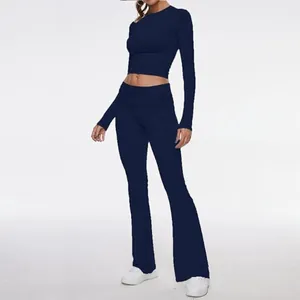 Detailed view of navy blue long sleeve crop top and matching flared yoga pants set
