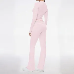 Back view detail of women's pale pink long-sleeve top and flared trousers set