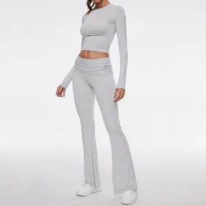 Close-up view of a grey long sleeve crop top and matching flared leggings two-piece set