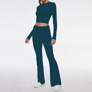 Two-piece activewear set with long sleeve crop top and flared leggings in teal