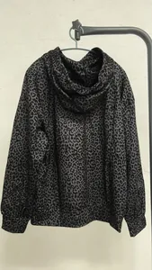 Detailed back view of a gray leopard print hooded sweatshirt in a loose retro style.