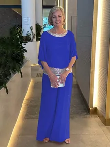 Blue two-piece set featuring sequin trim batwing top and wide-leg trousers for women