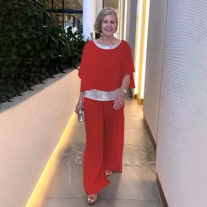 Elegant red two-piece set with sequin trim batwing top and wide-leg trousers