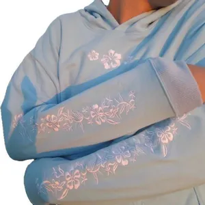 Light blue casual loose fit hoodie featuring intricate white floral embroidery on sleeves.