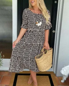Detailed view of summer tiered dress with polka dot print and short ruffled sleeves
