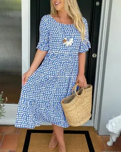 Blue and white polka dot summer midi dress featuring a tiered skirt and ruffled sleeves