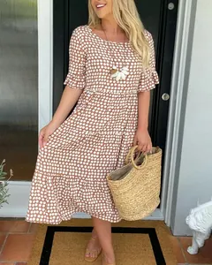 Elegant summer fashion look featuring a brown tiered midi dress with white patterns