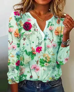 Detailansicht des farbenfrohen Blumenprints auf einem mintgrünen V-Ausschnitt Langarmshirt