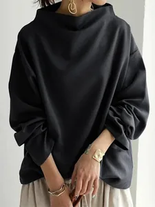 Detail of a loose black long-sleeved top with a stylish wide funnel neckline.