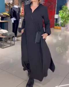 Detail view of an elegant loose-fitting black V-neck long sleeve maxi dress for women
