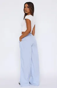 Elegant side view of woman wearing blue and white striped high-waisted wide-leg trousers