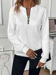 Close-up of white cable-knit texture and O-ring half-zip on women's casual sweatshirt