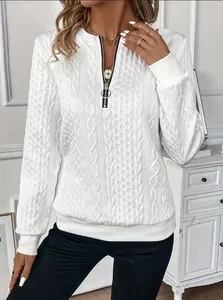 Close-up view of a stylish white cable-knit textured sweatshirt with a front quarter-zip closure