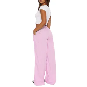 Back view of pink and white striped wide-leg high-waisted trousers on a model.