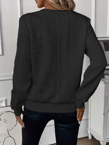 Back view of women's black cable knit sweatshirt with textured pattern and ribbed cuffs