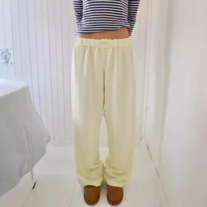 Women's stylish light yellow wide-leg trousers with high-waist elastic band and loose fit