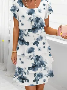 Detailed view of spring chiffon short-sleeve dress featuring elegant blue floral print patterns