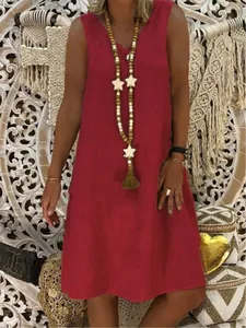 Close-up of a stylish red V-neck sleeveless tank dress worn with a bohemian star necklace