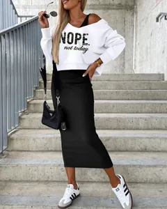 Full body view of women's white sweatshirt with NOPE print and black maxi skirt