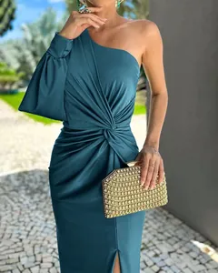 Detail view of a teal one-shoulder pleated dress with an elegant lantern sleeve.